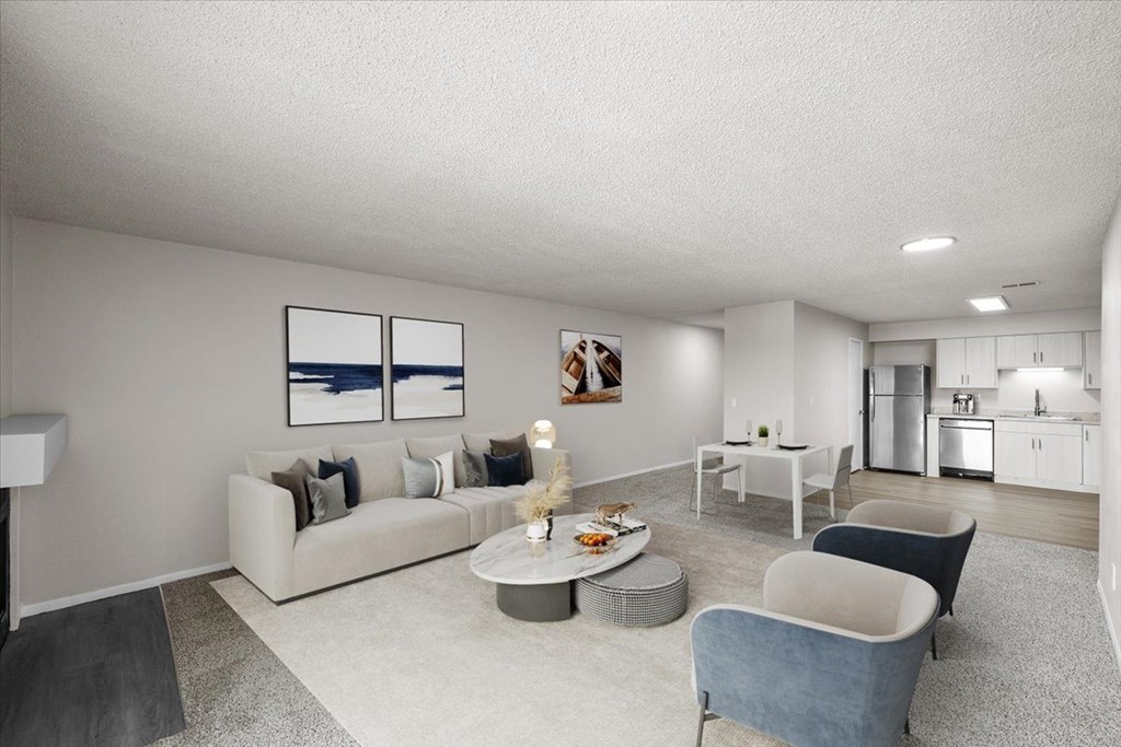 A modern living room with a grey sofa, a grey armchair, a grey coffee table, and a grey rug at Cloverset Active Adult Apartments, Kansas City