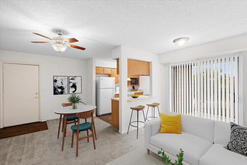 a living room and kitchen with a couch and a table at Wind River Lodge, Lenexa, 66219