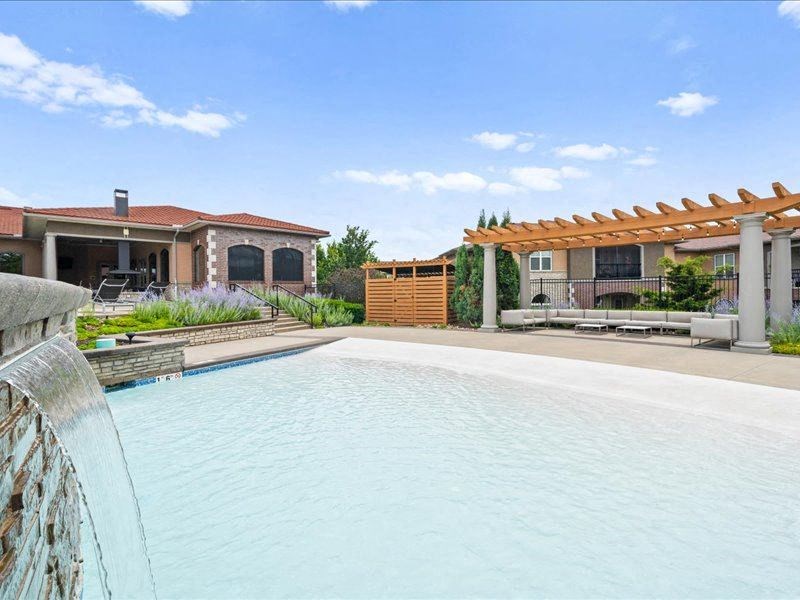 a large swimming pool in front of a house