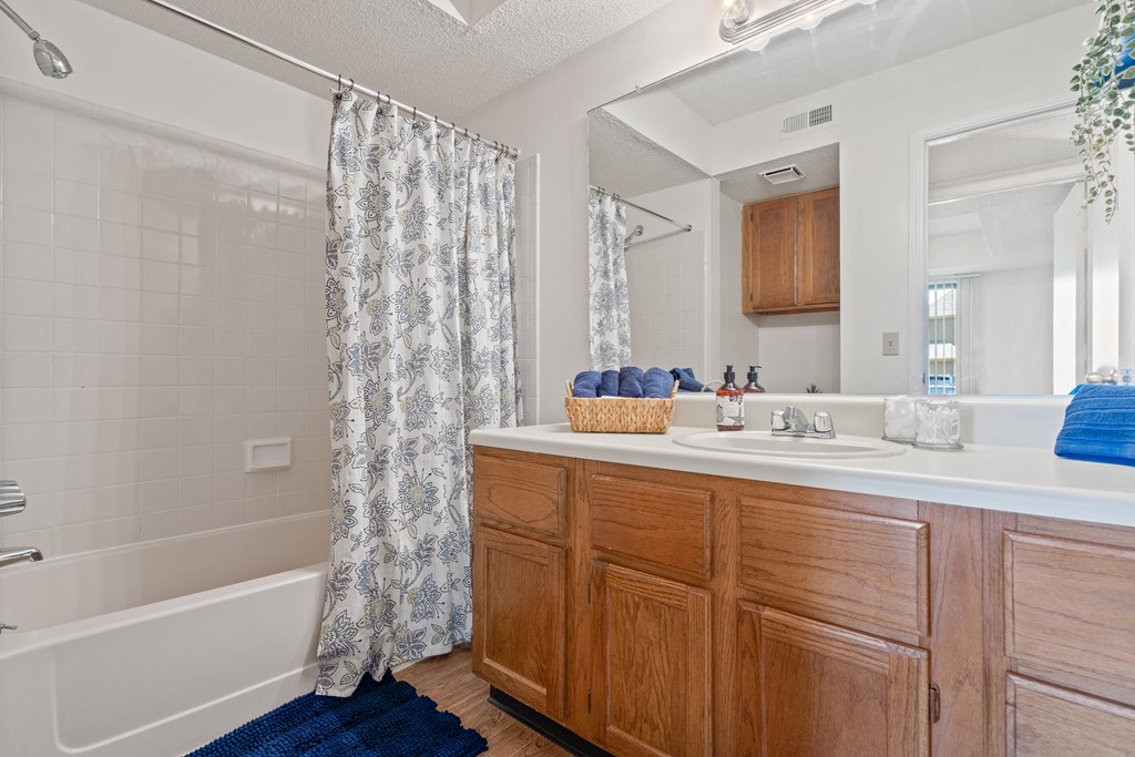 a bathroom with a bathtub and a sink at Waterford Place Apartments & Townhomes, Overland Park