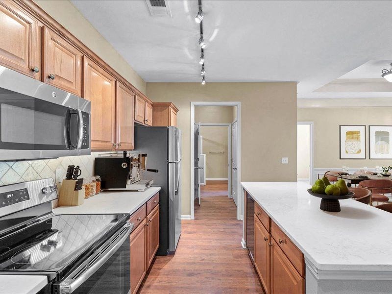 a kitchen with wooden cabinets and stainless steel appliances