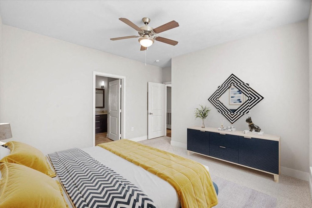 a bedroom with a bed and a ceiling fan