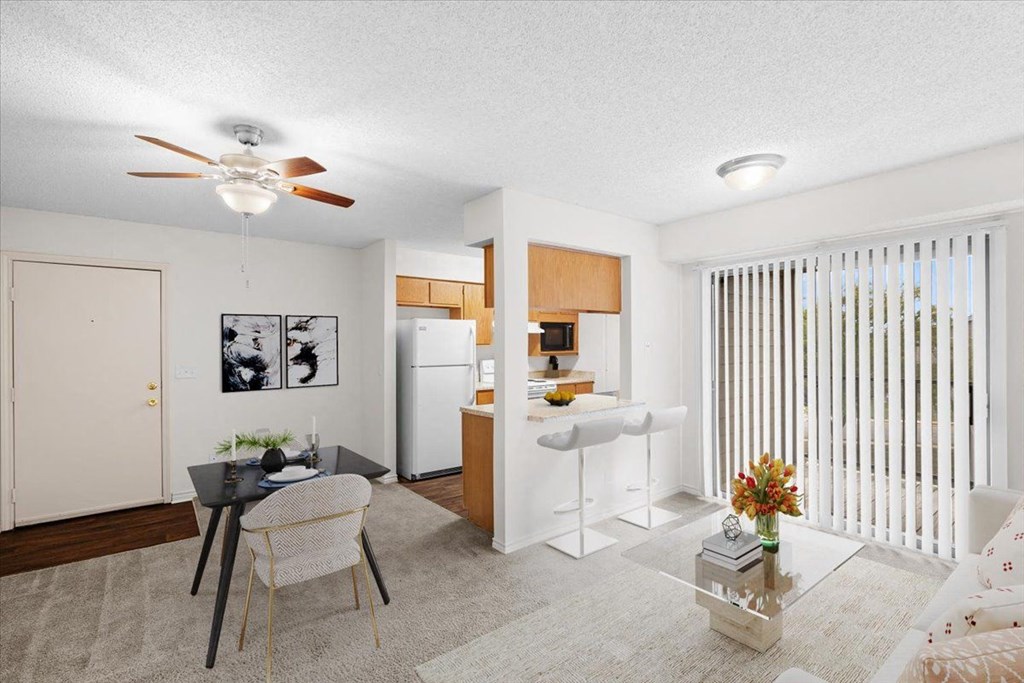 a living room with a kitchen and a ceiling fan at Wind River Lodge, Lenexa, 66219