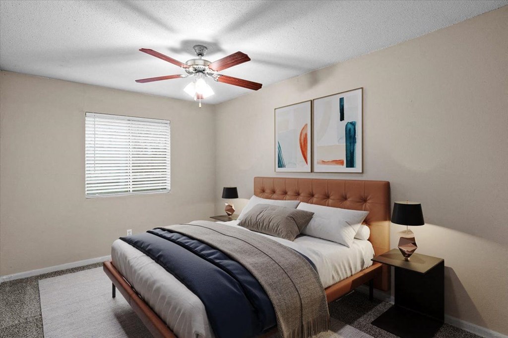 a bedroom with a bed and a ceiling fan