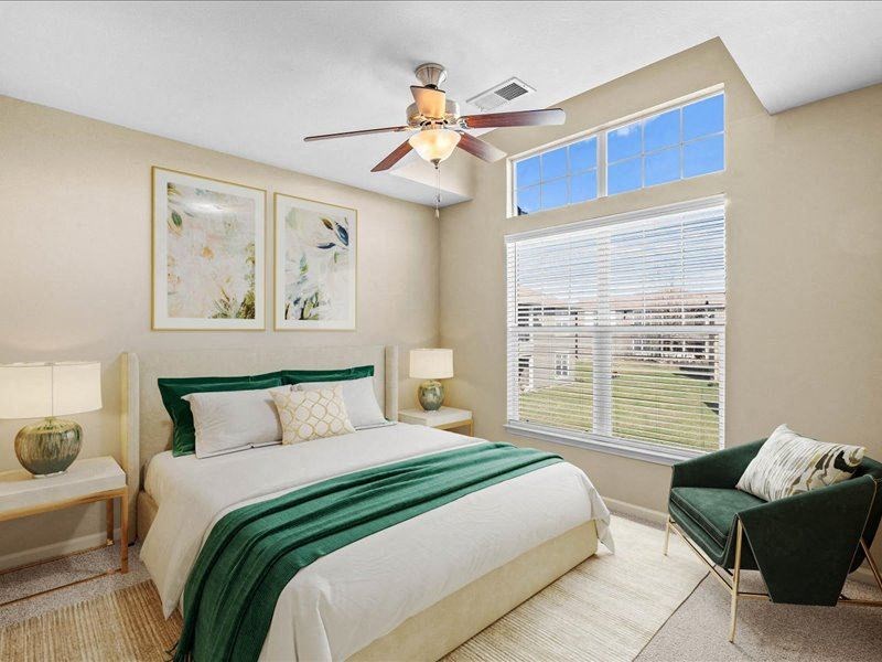 a bedroom with a bed and a ceiling fan