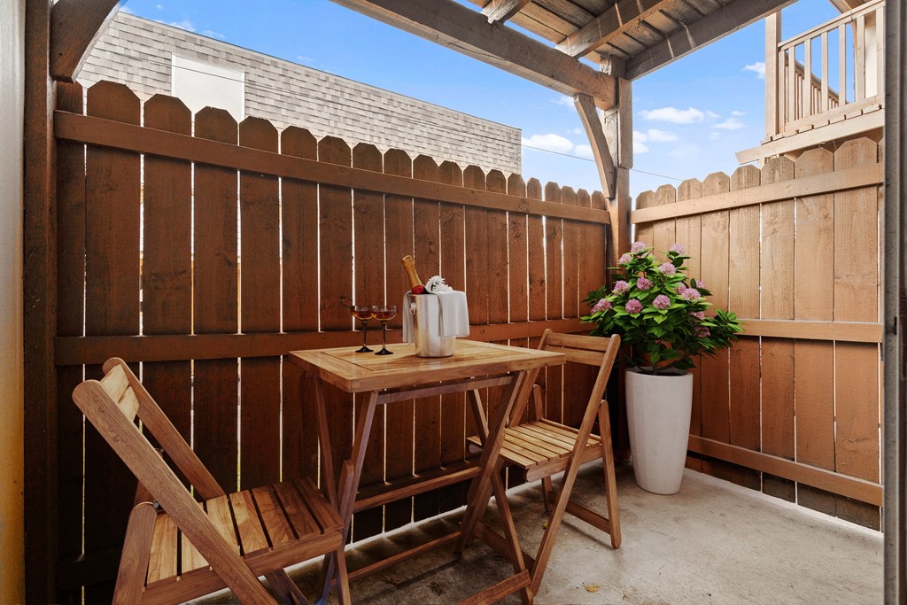 a small patio with a table and two chairs at Malvern Hill Apartment Homes, 66103 66214
