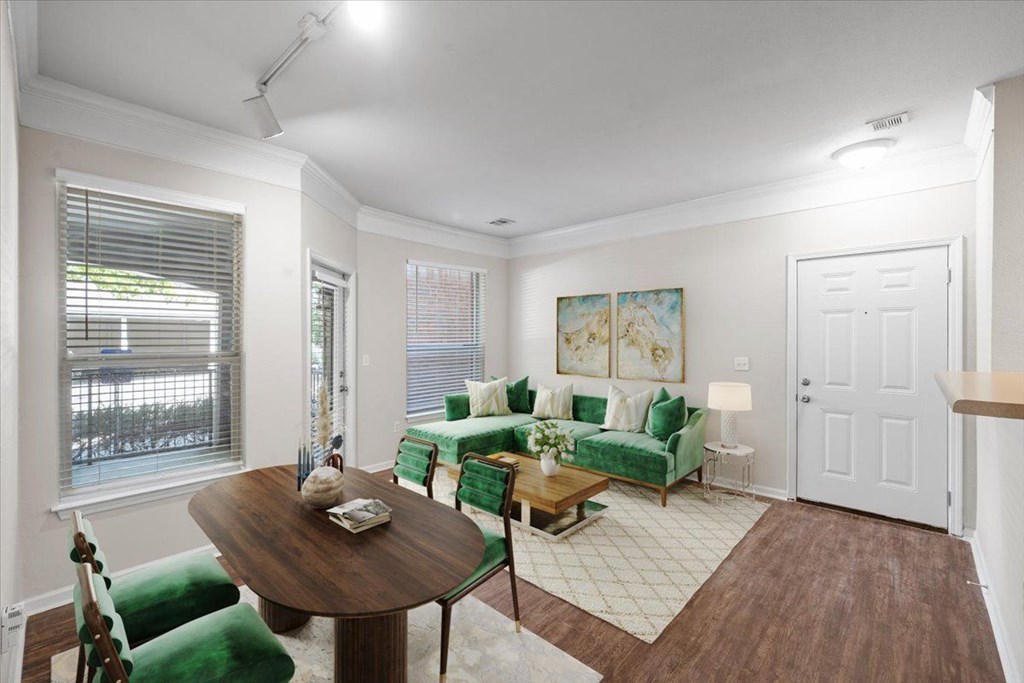 A living room with a green couch and a wooden table. at Somerset Oaks Apartment Homes, Olathe, KS, 66062