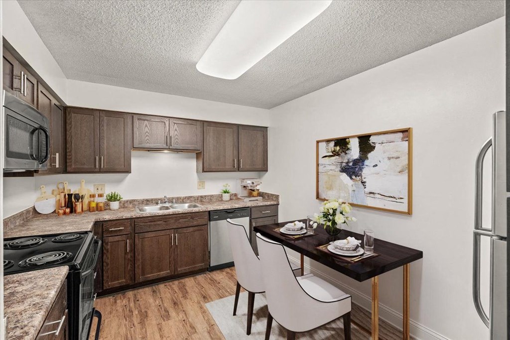 our apartments offer a kitchen and dining area with a table