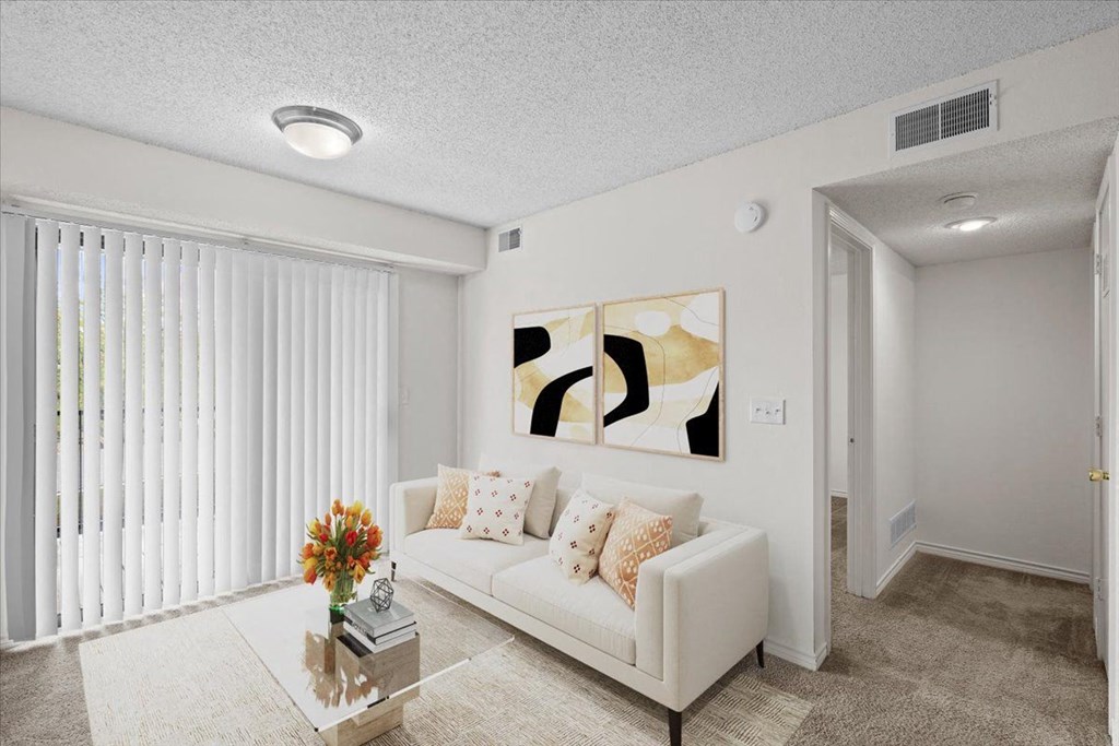 a living room with a couch and a table at Wind River Lodge, Lenexa