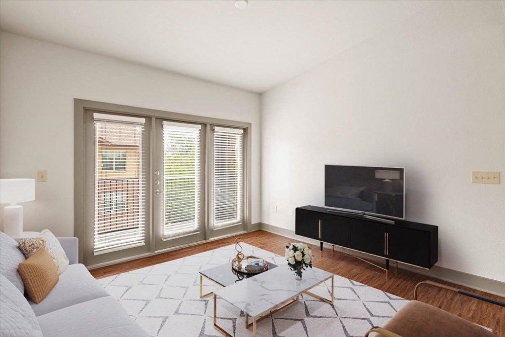 a living room with white walls and hardwood floors at Cypress at Lewisville Apartment Homes, Lewisville