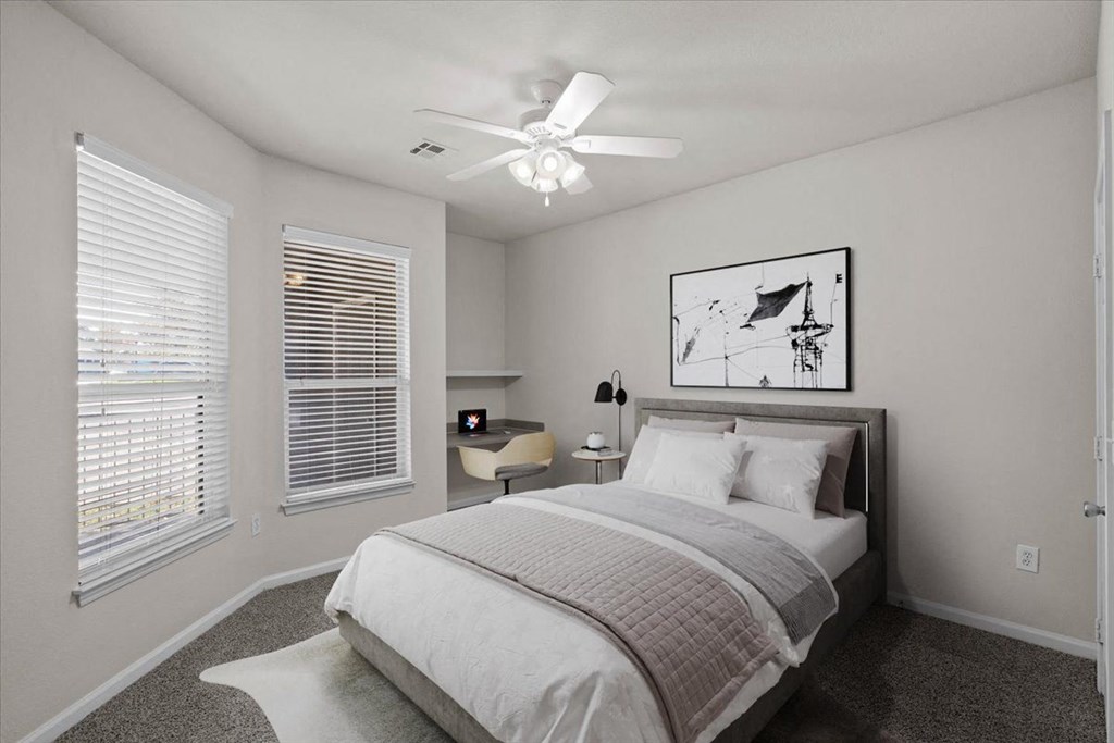 A bedroom with a bed, nightstand, and a ceiling fan. at Somerset Oaks Apartment Homes, Olathe, KS, 66062