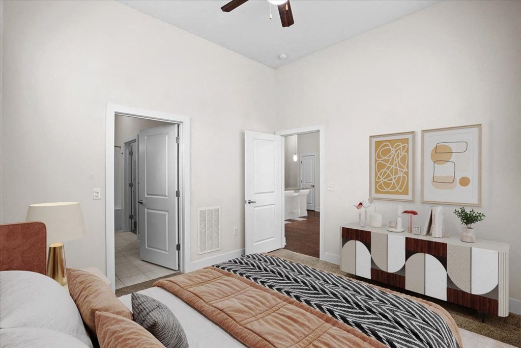 a bedroom with a bed and a door to a bathroom