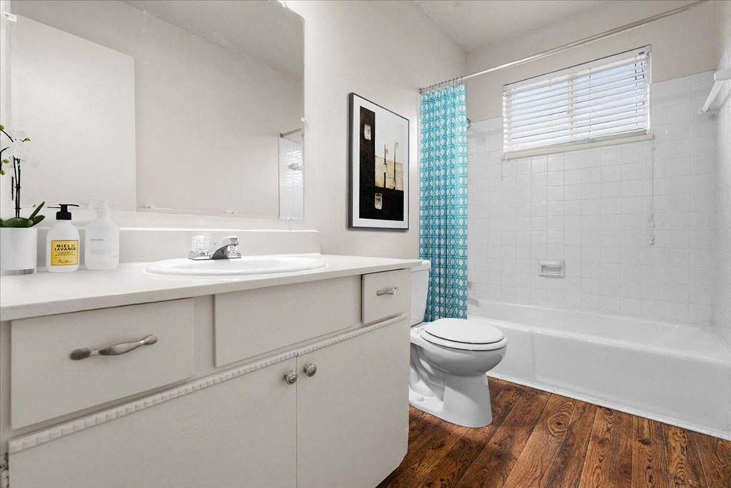Bathroom with a toilet and sink  at Louisburg Square Apartments & Townhomes, Overland Park, KS