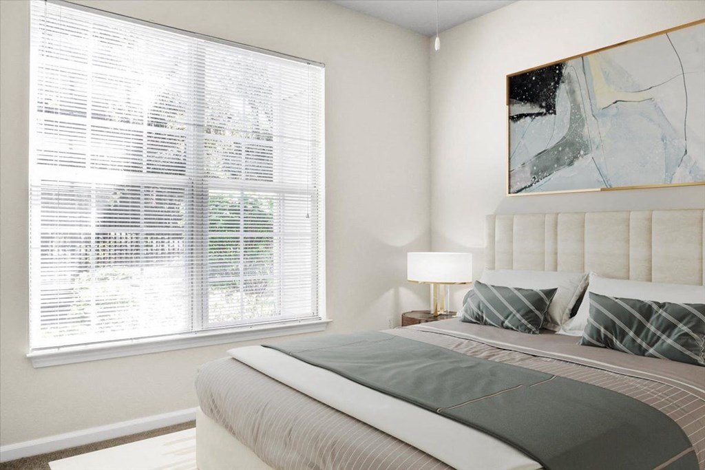 a bedroom with a bed and a large window at Wynnewood Farms Apartments, Overland Park, KS
