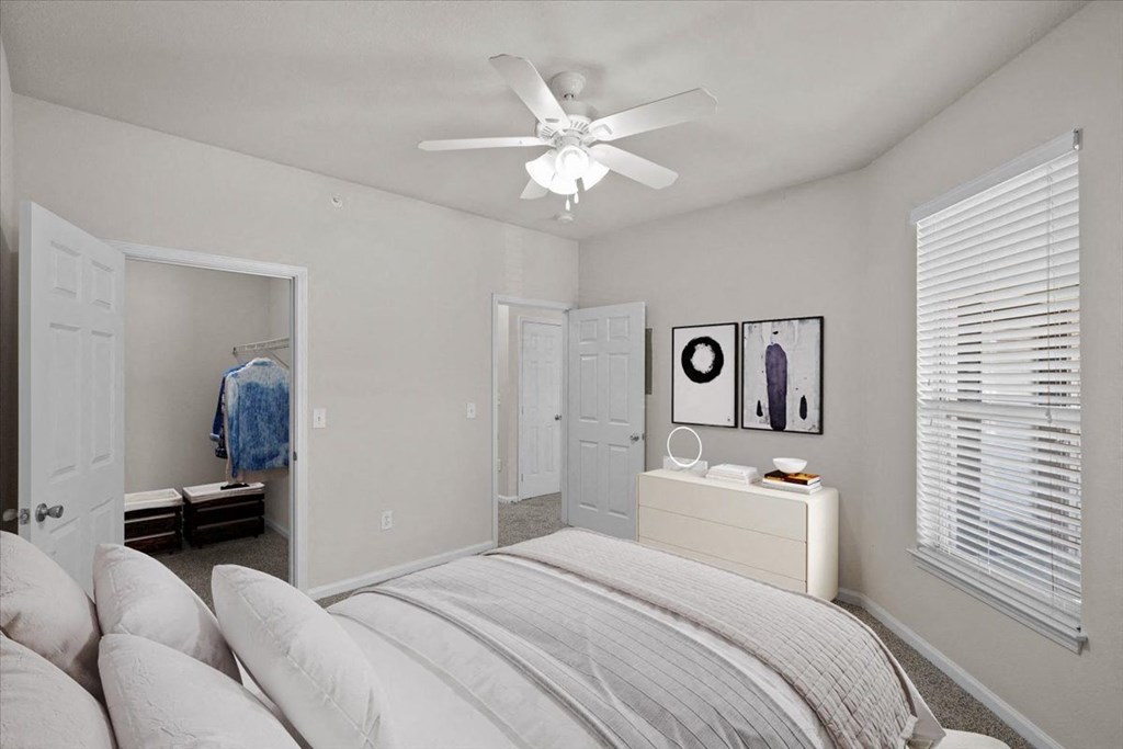 a bedroom with a bed and a ceiling lamp at Somerset Oaks Apartment Homes, Olathe, KS