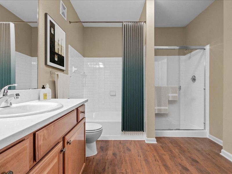 a bathroom with a sink toilet and shower