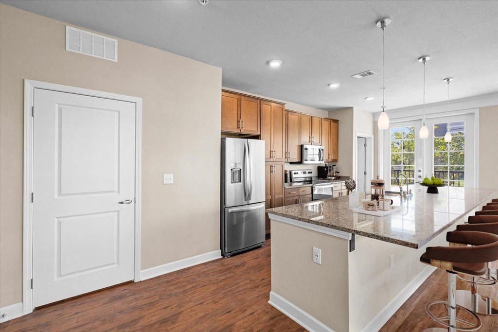 a kitchen with a large island and stainless steel appliances
