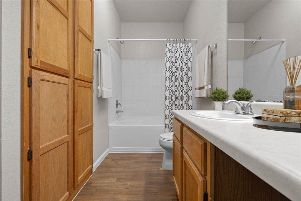 A bathroom with wooden doors and a white sink. at Somerset Oaks Apartment Homes, Kansas, 66062