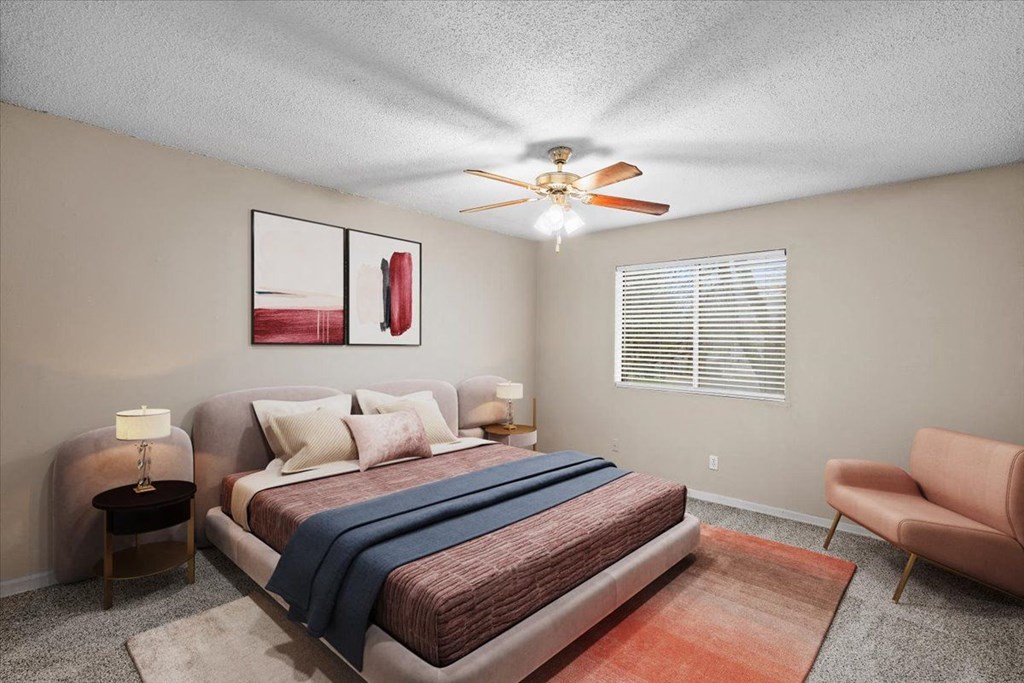 a bedroom with a bed and a ceiling fan