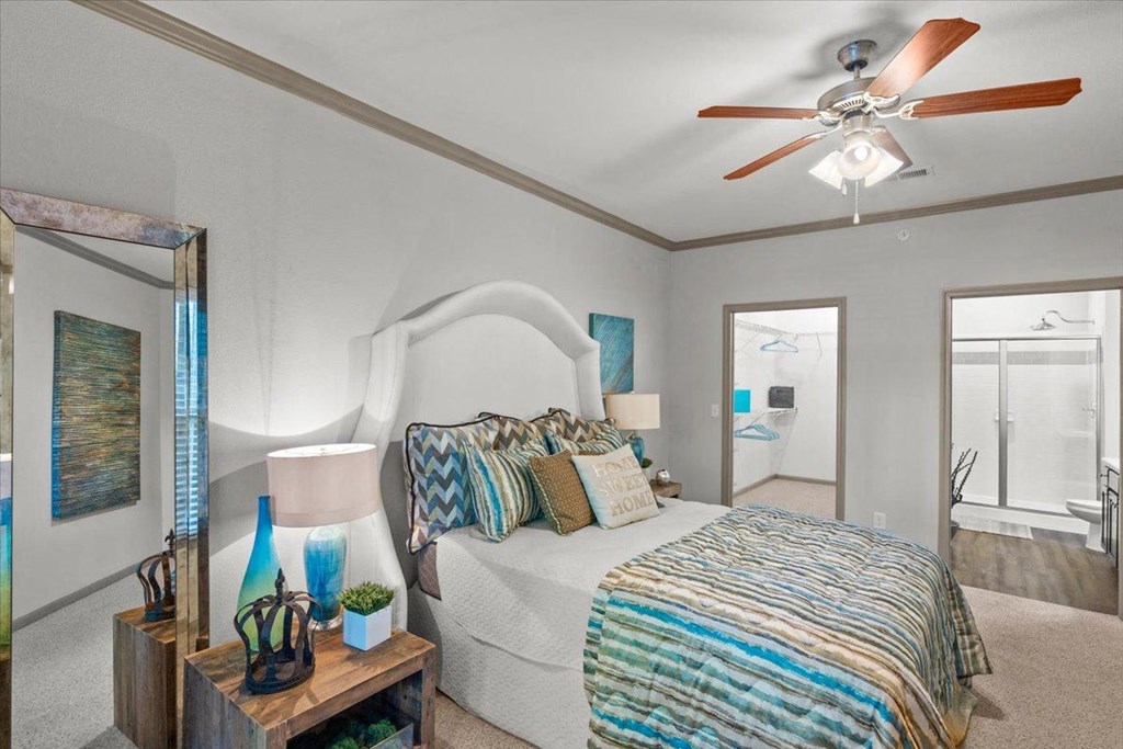 a bedroom with a bed and a ceiling fan