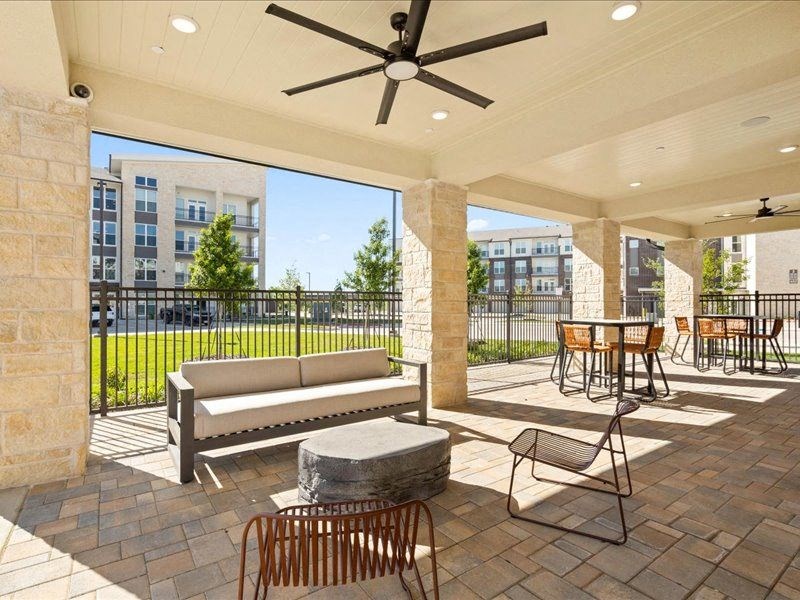 a patio with a couch and chairs and a table