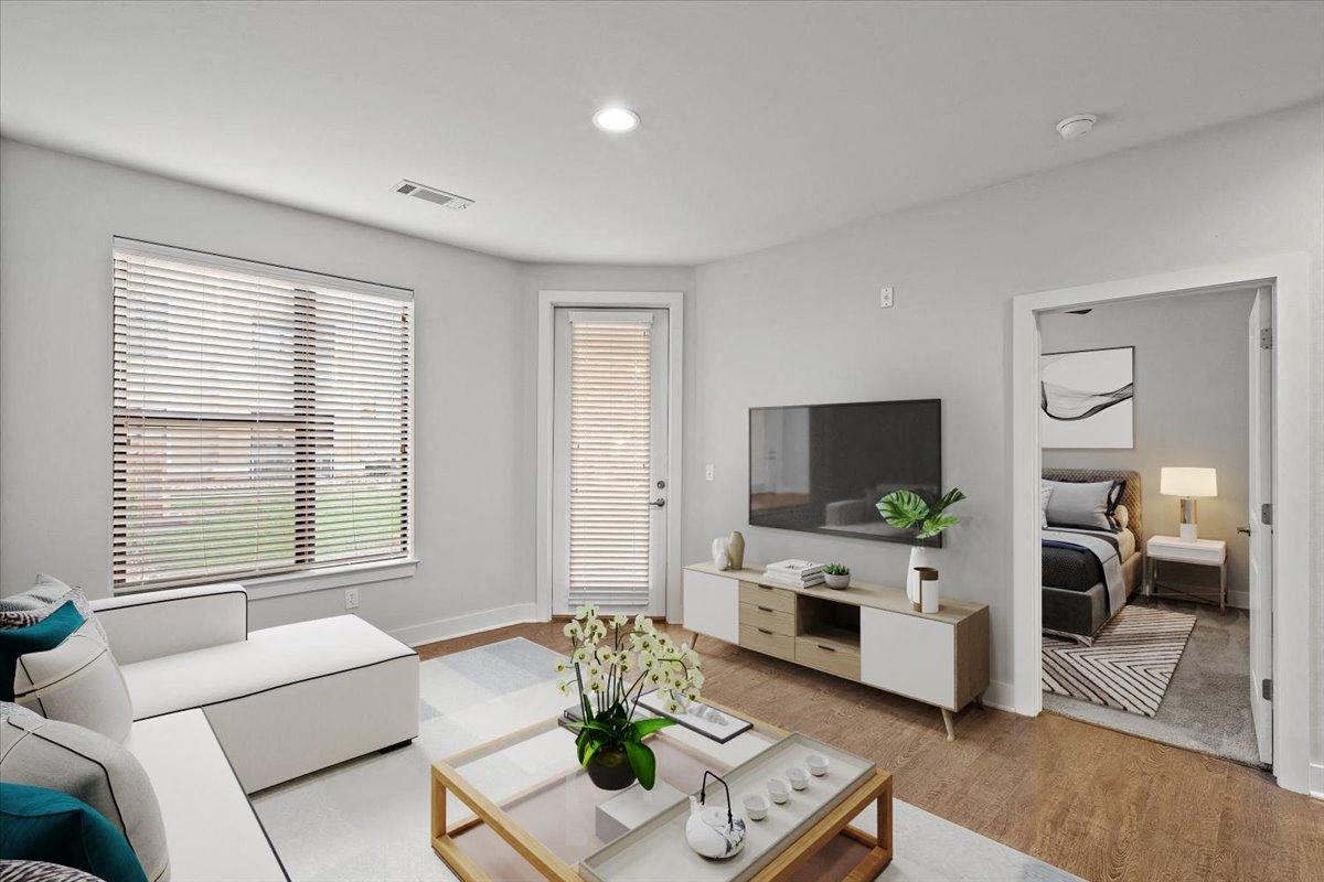 a living room with a white couch and a television