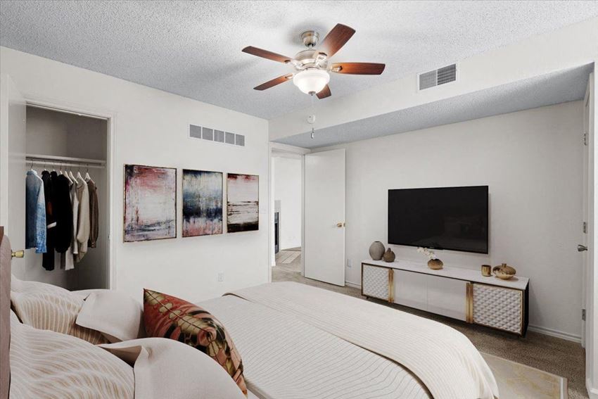 a bedroom with a bed and a ceiling fan