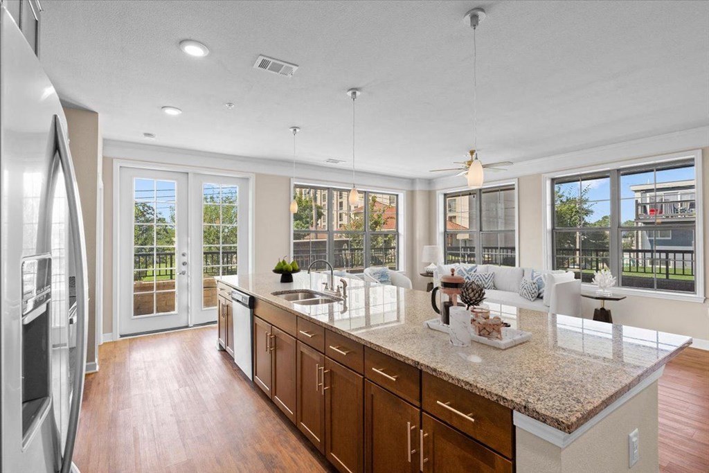 a kitchen with a large island next to a living room