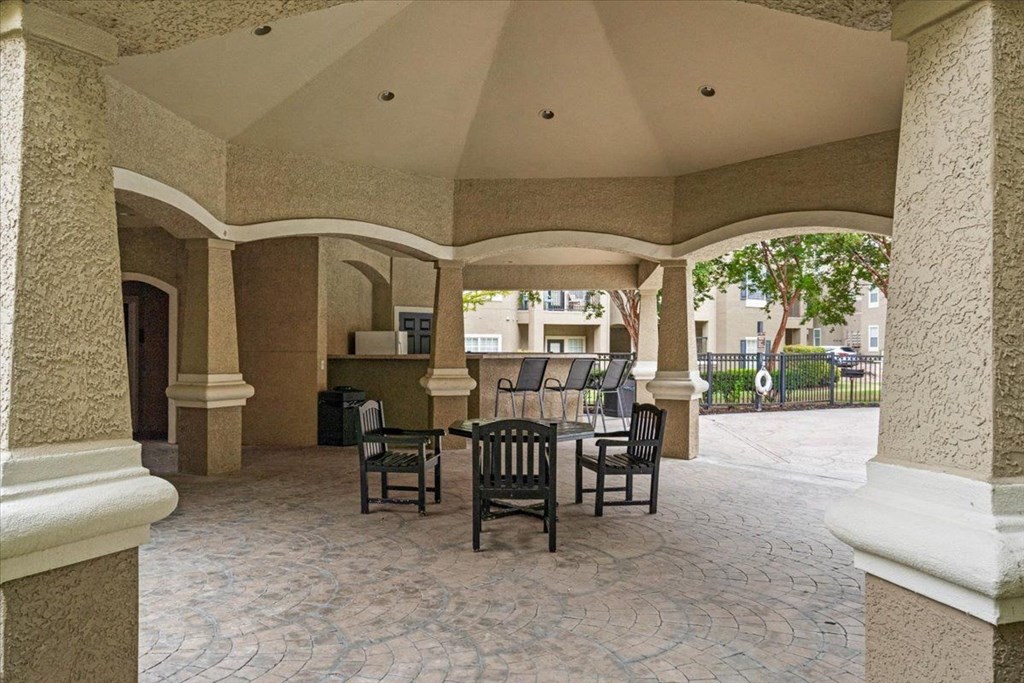 a patio with a table and chairs