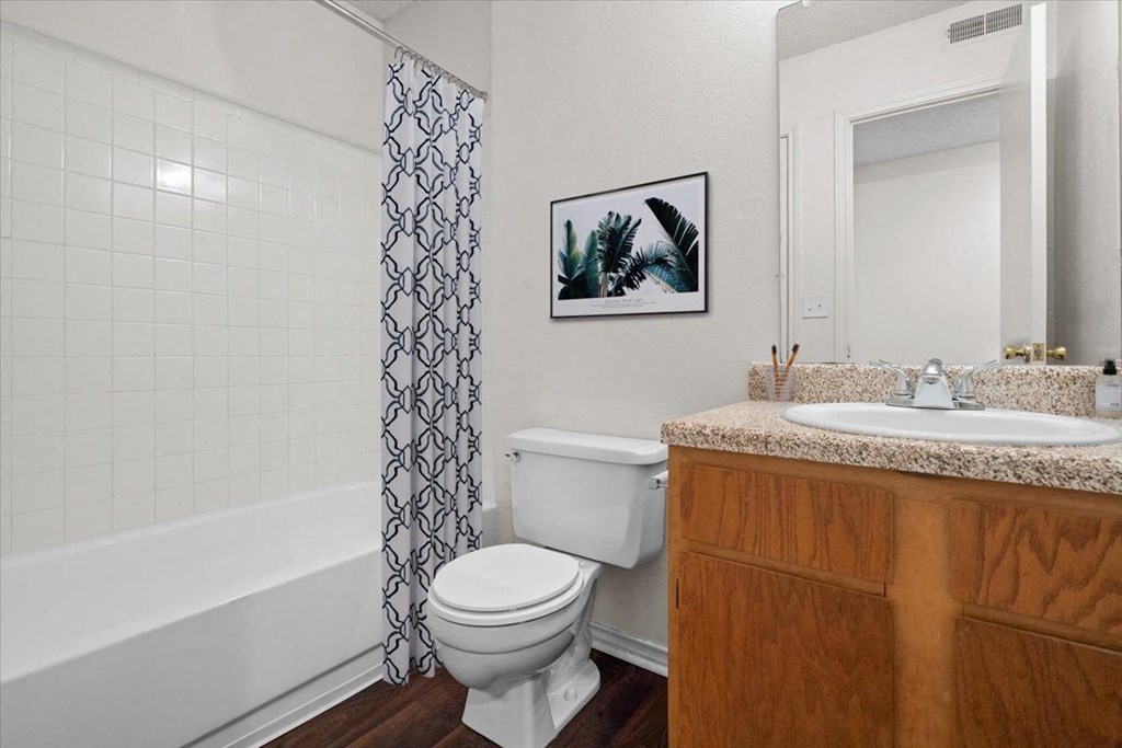 a bathroom with a sink toilet and bath tub at Wind River Lodge, Lenexa, KS