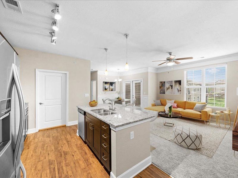 a living room with a kitchen and a couch