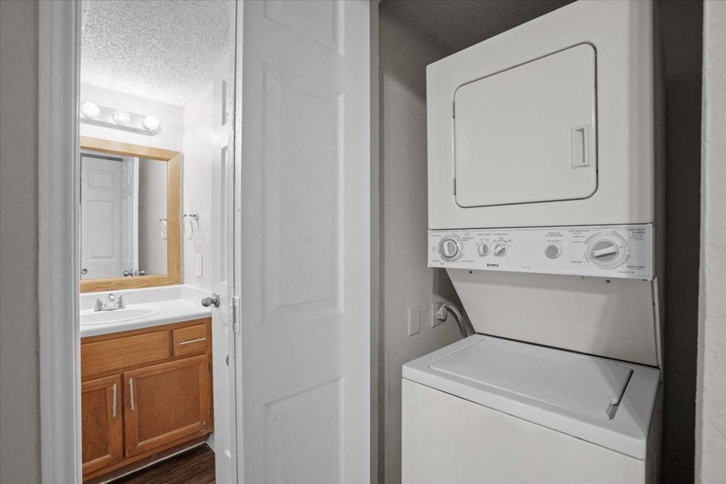 a white washer and dryer in a bathroom at Creekview Apartment Homes, Texas, 75254