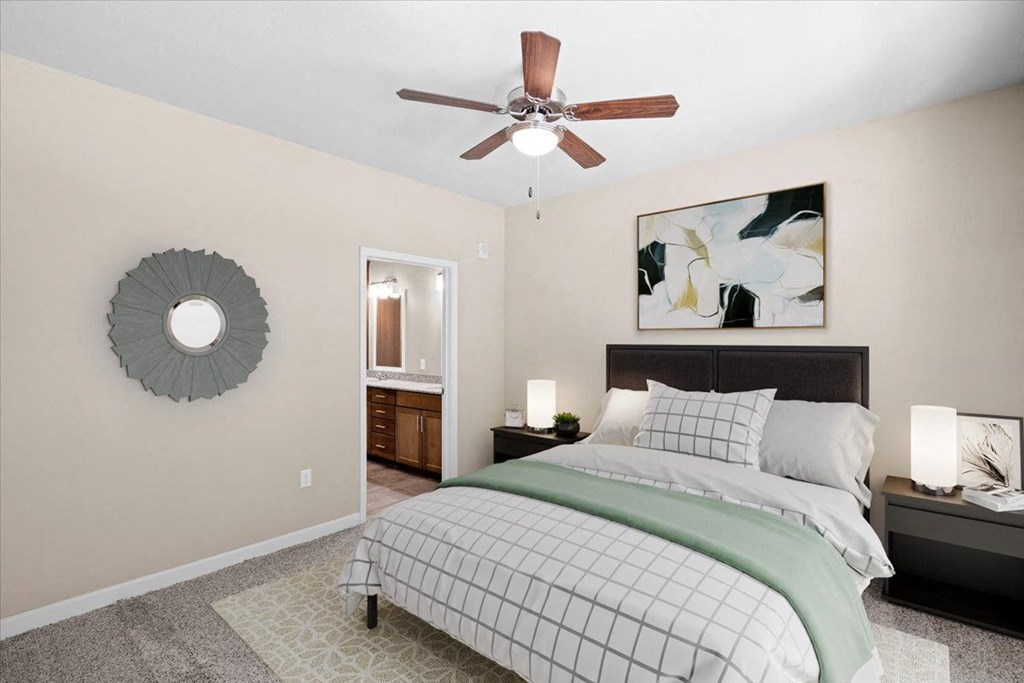 a bedroom with a bed and a ceiling fan