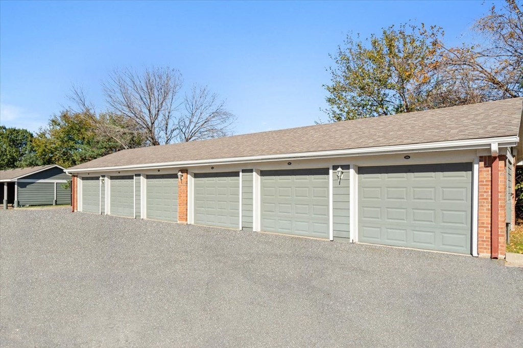 a row of garage doors in front of a house at Somerset Oaks Apartment Homes, Olathe, KS