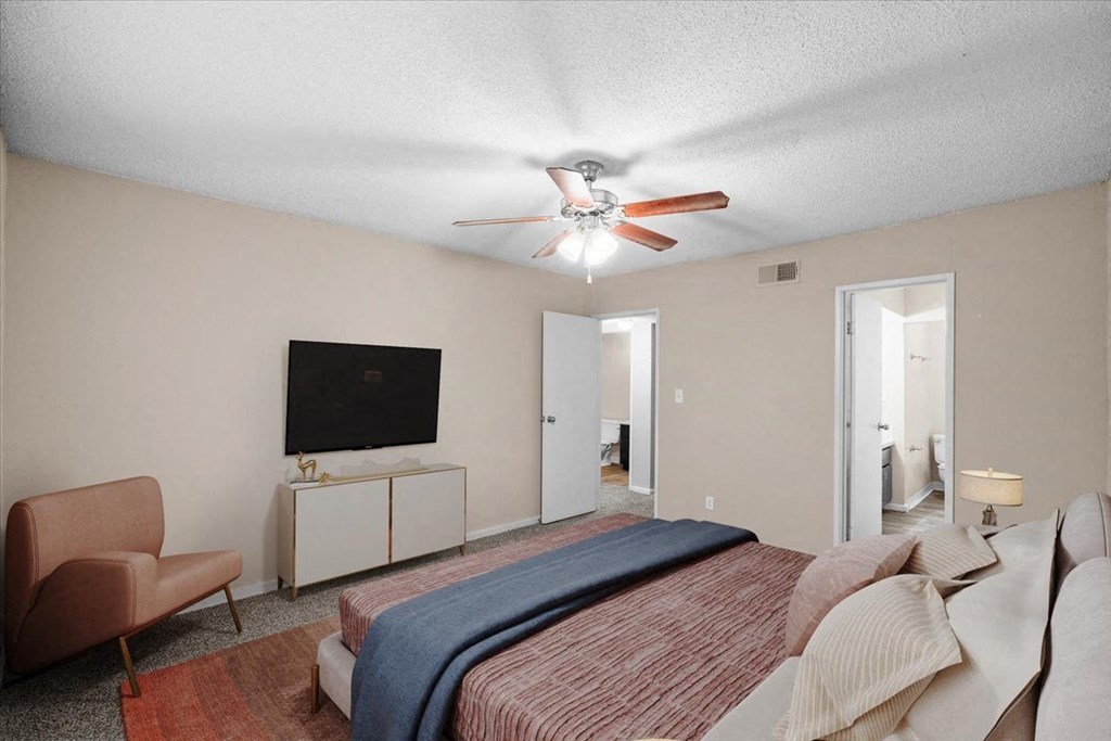 a bedroom with a bed and a ceiling fan