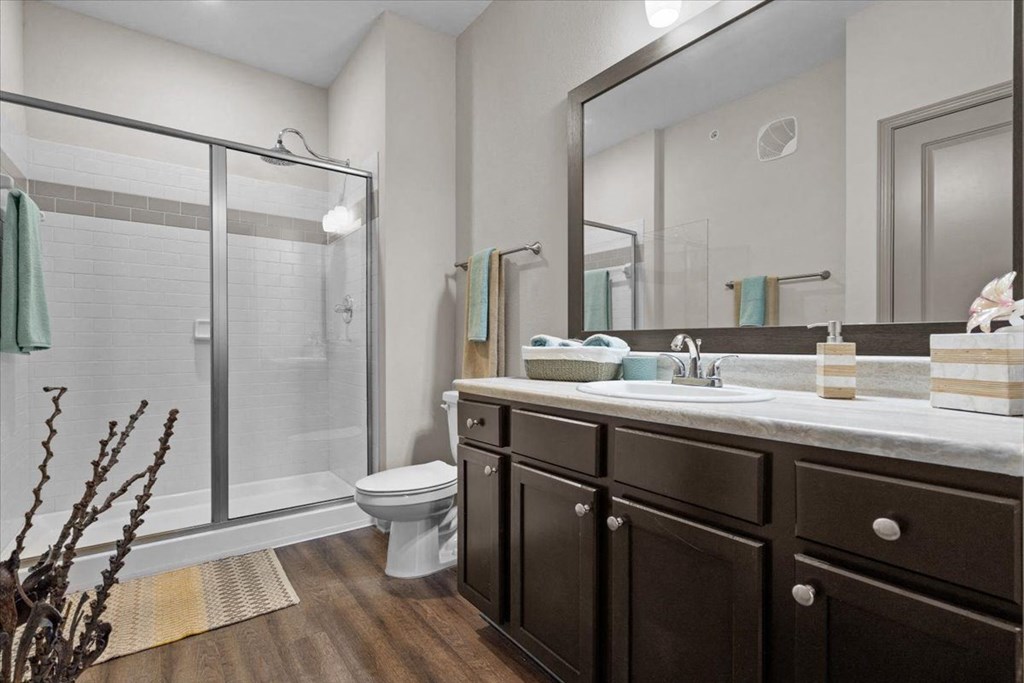 a bathroom with a toilet sink and shower