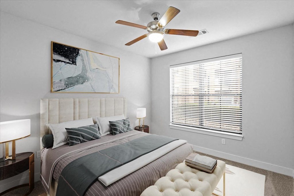 a bedroom with a large bed and a ceiling fan at 46 Penn Apartment Homes, Kansas City, Missouri