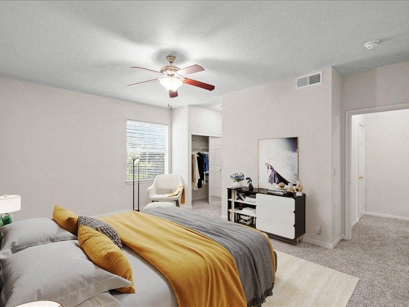 a bedroom with a bed and a ceiling fan