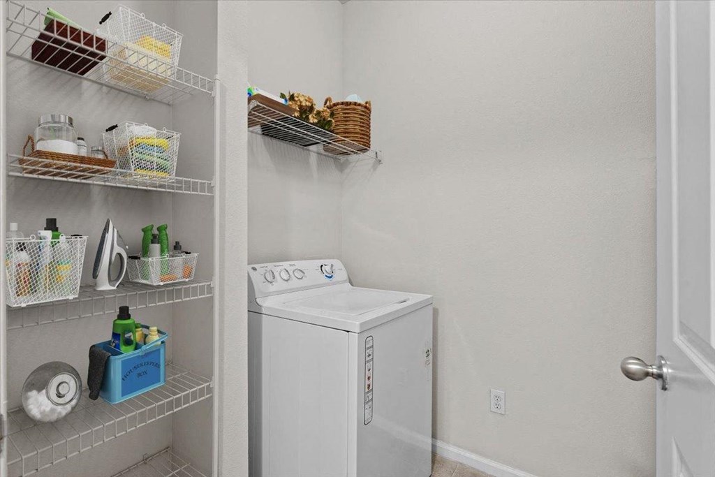 a white washer and dryer in a room with a closet