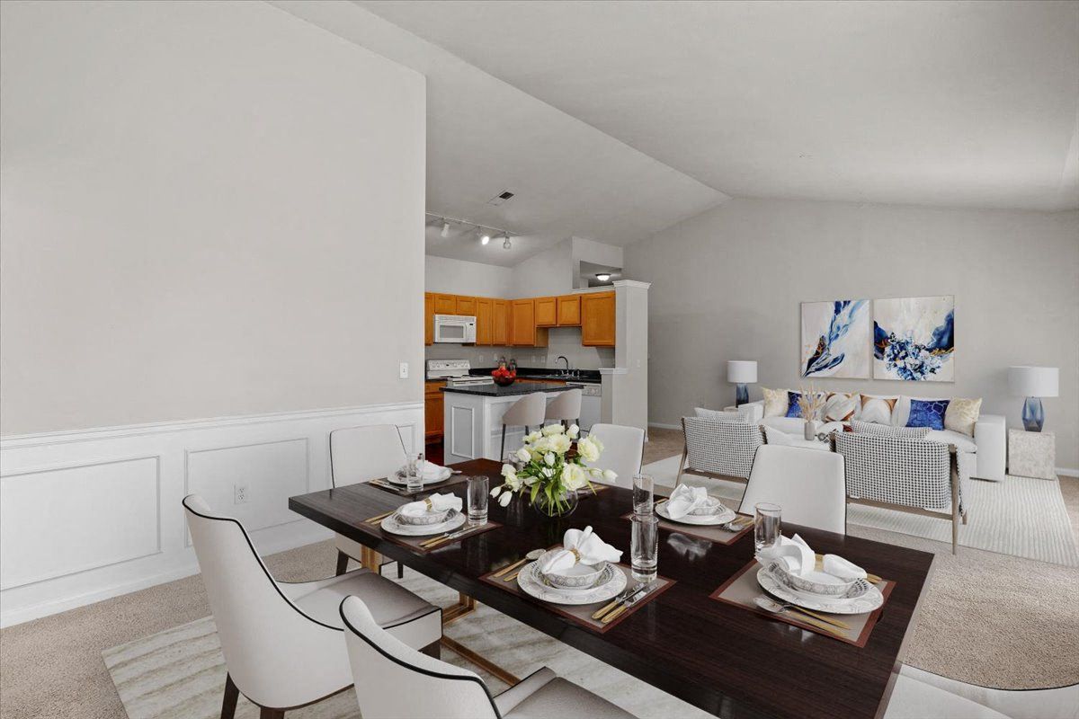 a dining room and living room with a table and chairs