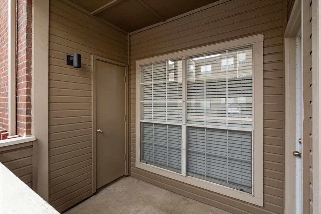 a front porch with a large window and a door at Creekview Apartment Homes, Dallas, Texas