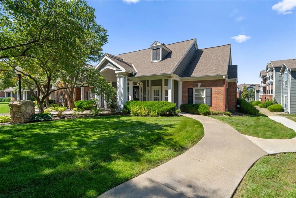 A house with a well-manicured lawn and a stone pathway leading to the front door. at Somerset Oaks Apartment Homes, Olathe, Kansas