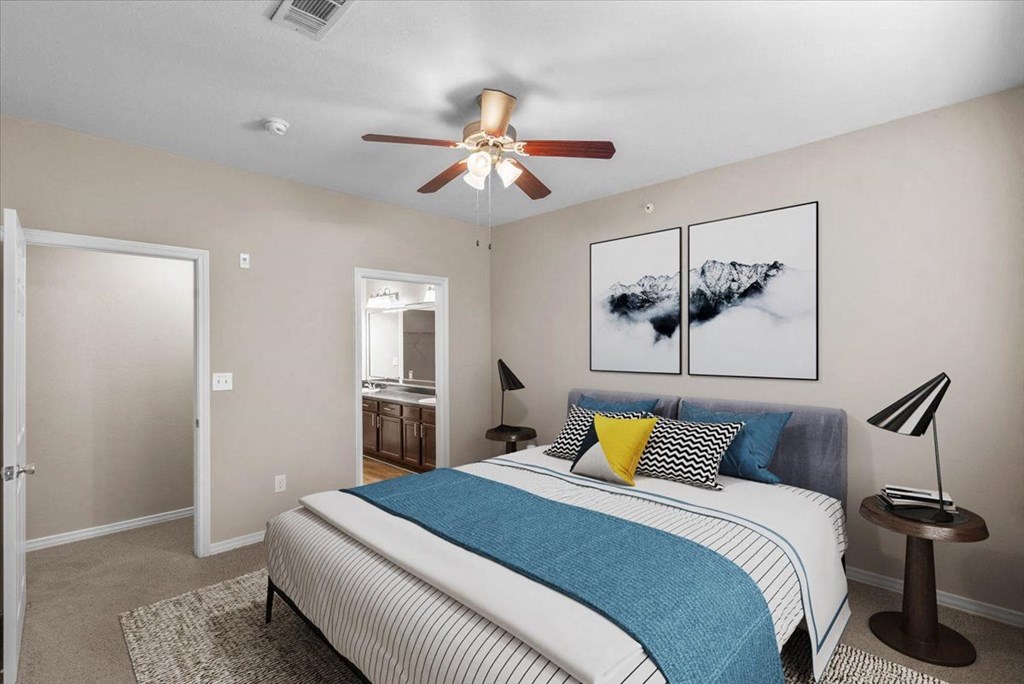 a bedroom with a bed and a ceiling fan at The Clairborne Apartment Homes, Grand Prairie, TX, 75050