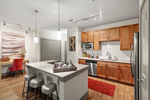 Kitchen with wooden cabinets at Ovation at Lewisville, Lewisville