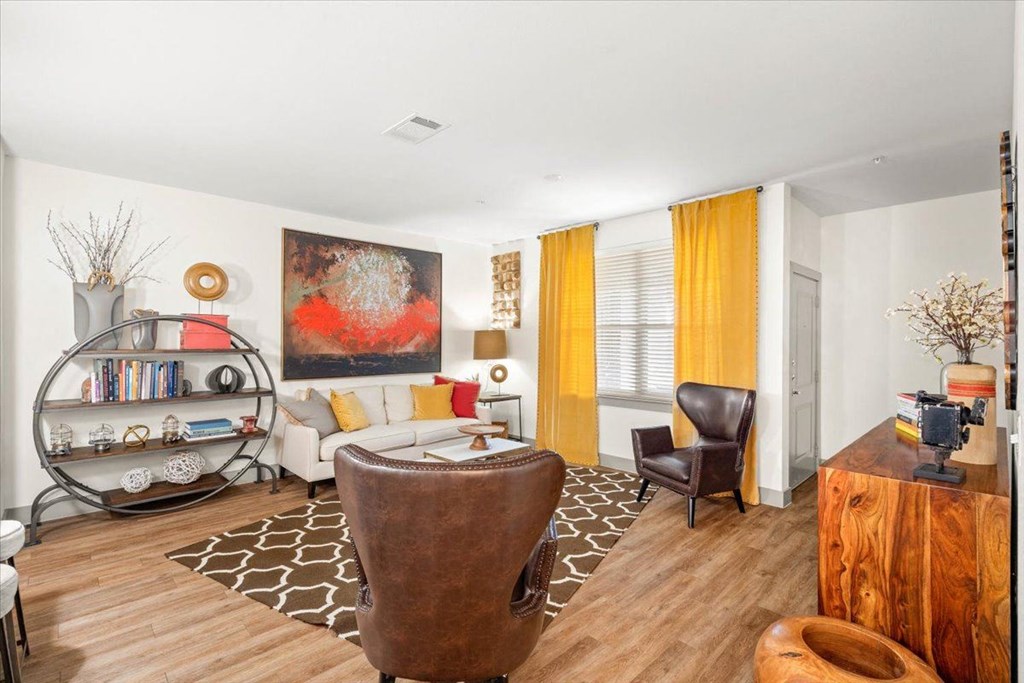 a living room with a white couch and yellow curtains