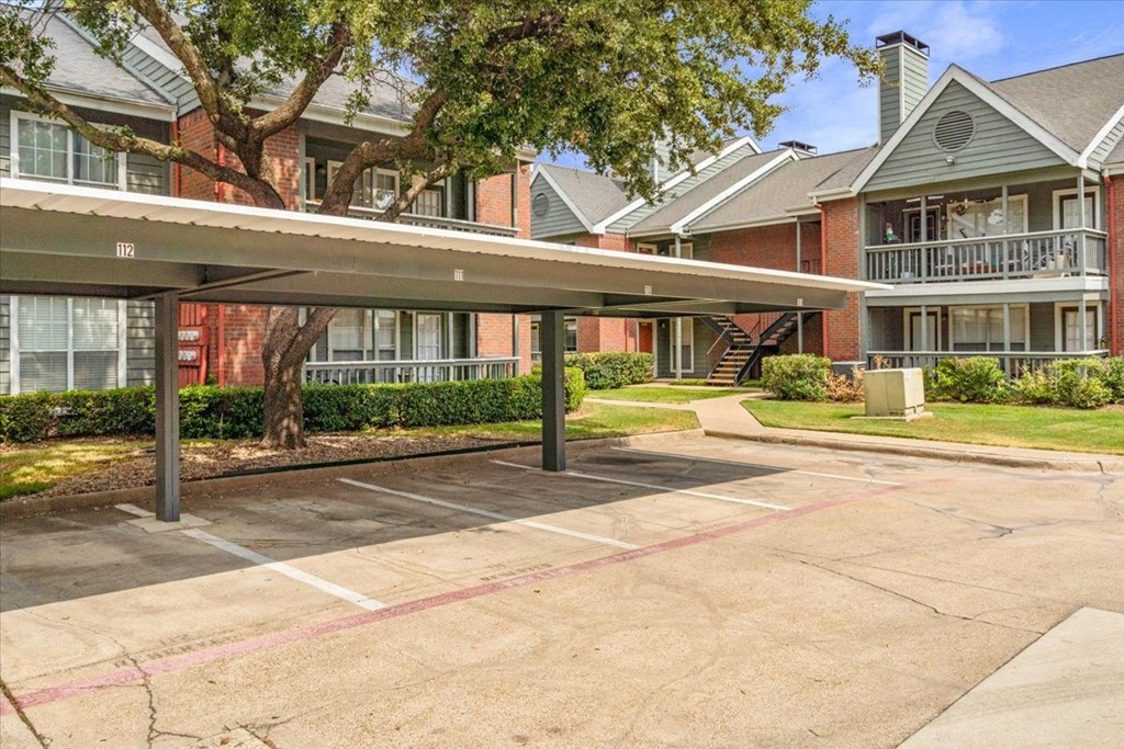 a carport in front of a brick building at Pear Ridge, Dallas