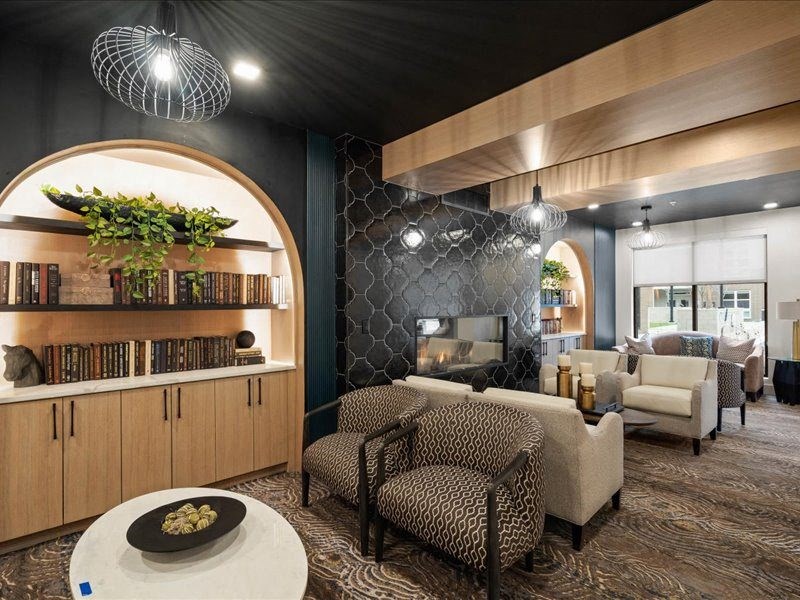 a living room with couches and chairs and a fireplace