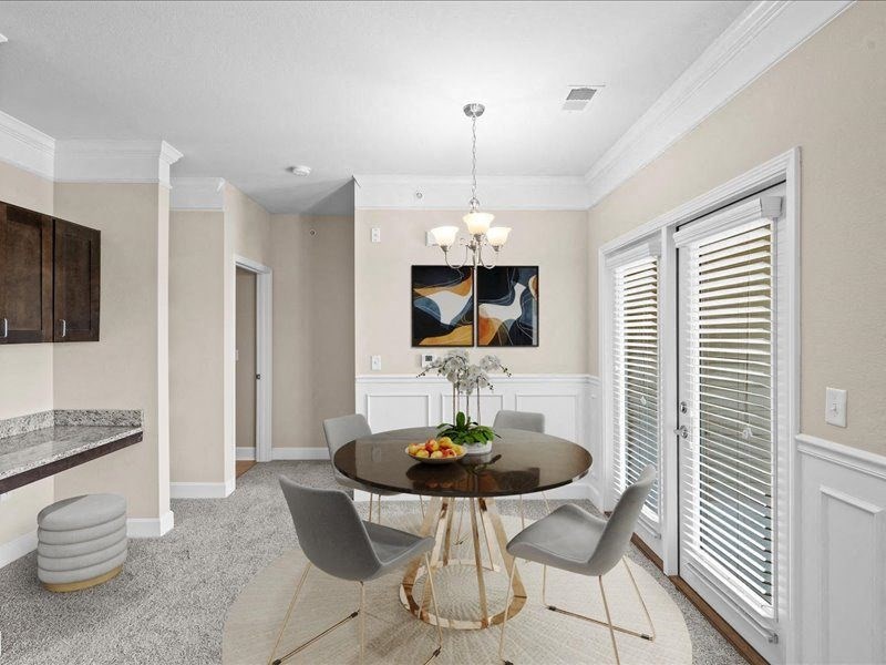 a dining room with a table and chairs