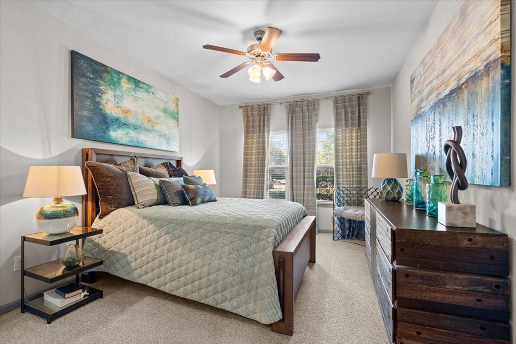 a bedroom with a bed and a ceiling fan