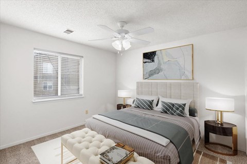 a bedroom with a bed and a ceiling fan at Deerfield Apartments, Olathe, Kansas